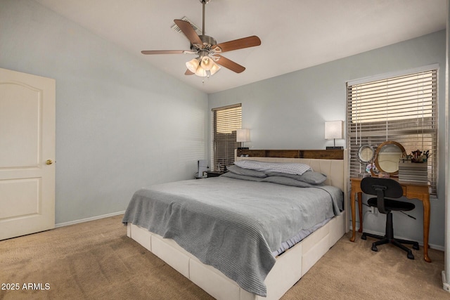 carpeted bedroom with vaulted ceiling and ceiling fan