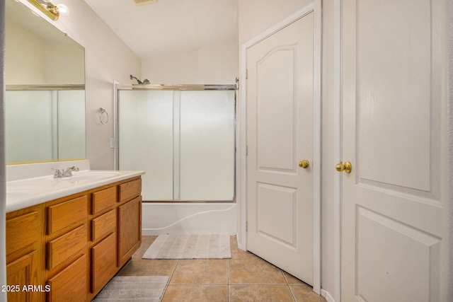 bathroom with tile patterned floors, vanity, and shower / bath combination with glass door