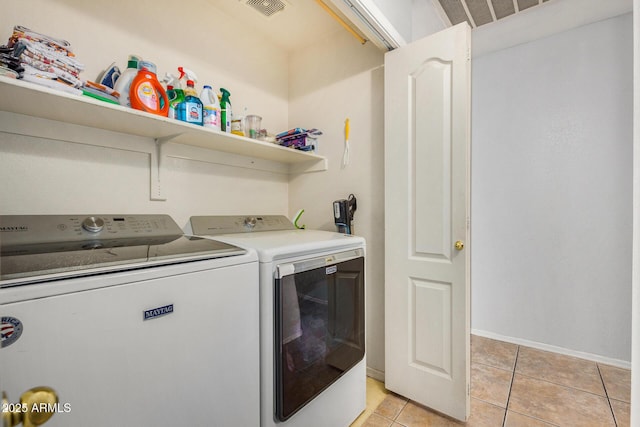 washroom with independent washer and dryer and light tile patterned floors