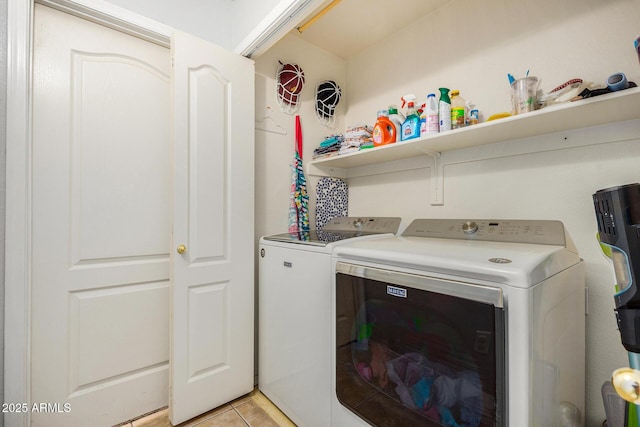 laundry area featuring light tile patterned flooring and washer and dryer