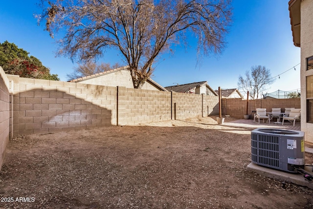 view of yard with outdoor lounge area, a patio area, and central AC