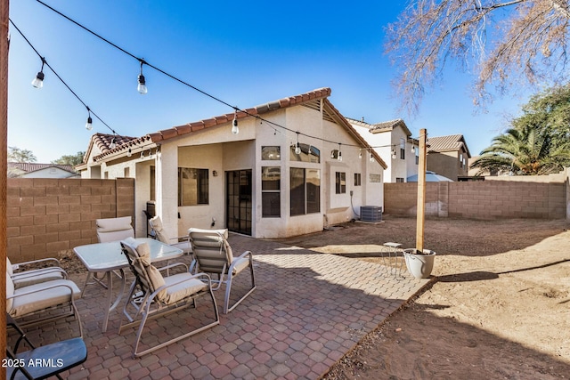 rear view of property with a patio area and central air condition unit