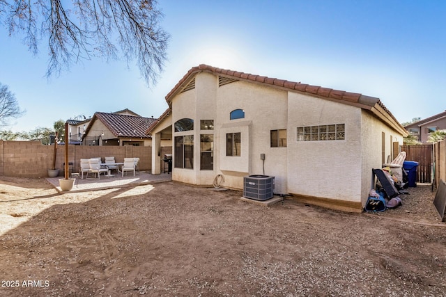 rear view of house featuring a patio area and central air condition unit