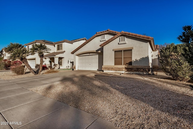 mediterranean / spanish home with a garage