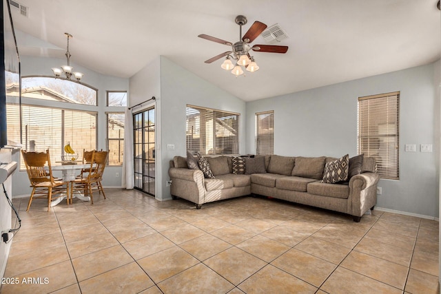 tiled living room featuring ceiling fan with notable chandelier and vaulted ceiling