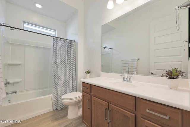 full bathroom with shower / bath combo, hardwood / wood-style floors, vanity, and toilet