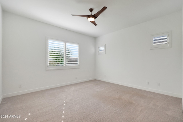 unfurnished room featuring light carpet and ceiling fan