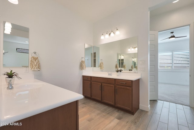 bathroom featuring wood-type flooring, ceiling fan, and vanity