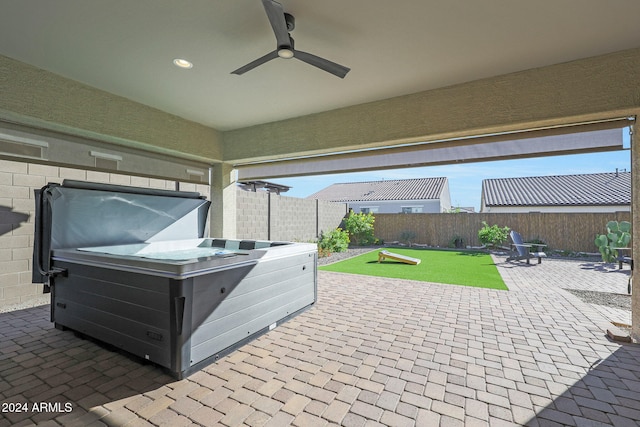 view of patio with a hot tub and ceiling fan