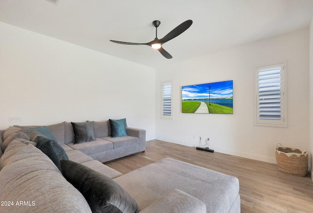 living room with light hardwood / wood-style flooring, a healthy amount of sunlight, and ceiling fan