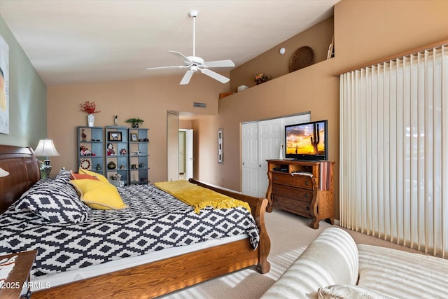 carpeted bedroom with vaulted ceiling, a closet, and ceiling fan