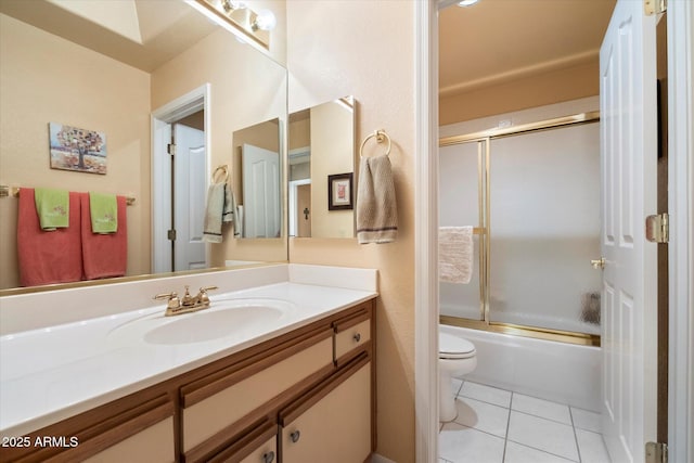 full bathroom featuring vanity, tile patterned floors, toilet, and combined bath / shower with glass door