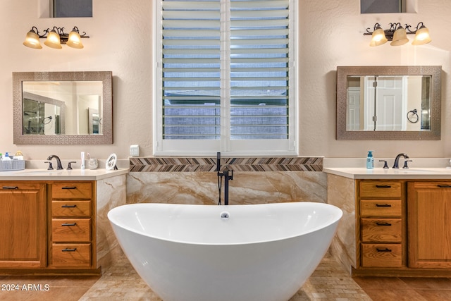 bathroom featuring tile patterned floors, vanity, a bath, and tile walls