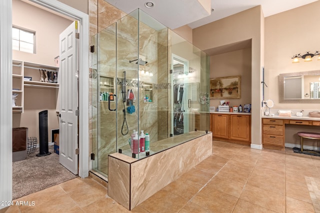 bathroom with vanity, tile patterned floors, and a shower with door