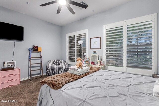 bedroom featuring ceiling fan and dark carpet