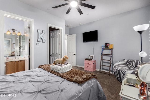 bedroom featuring ensuite bath, ceiling fan, and dark carpet