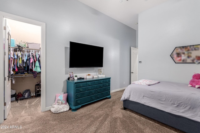 carpeted bedroom with a spacious closet and a closet