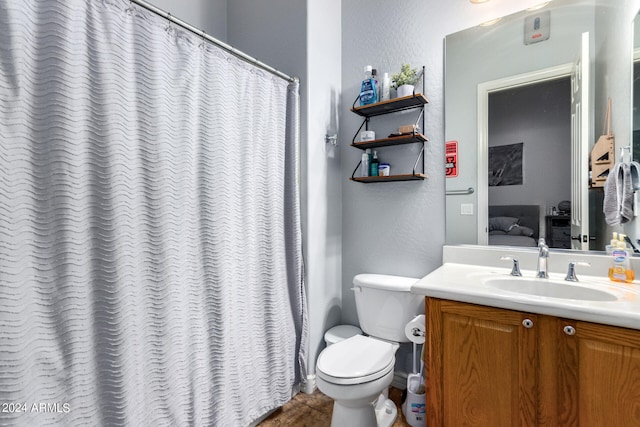 bathroom featuring tile patterned flooring, vanity, and toilet