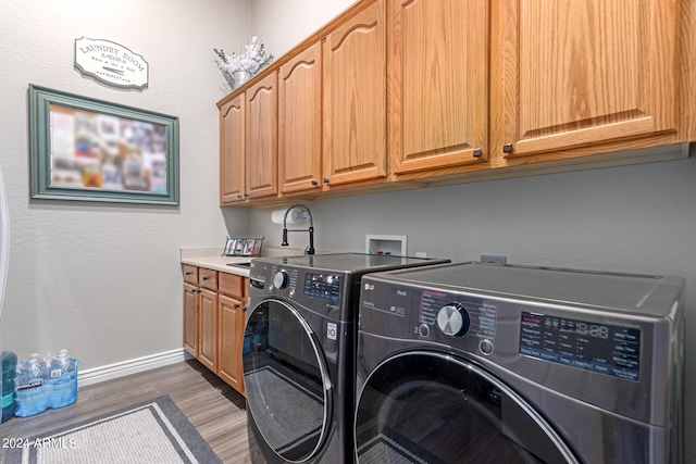 laundry room featuring cabinets, dark hardwood / wood-style flooring, separate washer and dryer, and sink