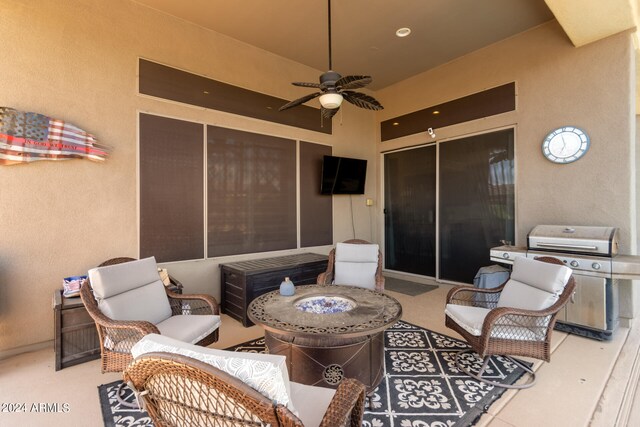 view of patio with an outdoor living space with a fire pit, ceiling fan, and a grill