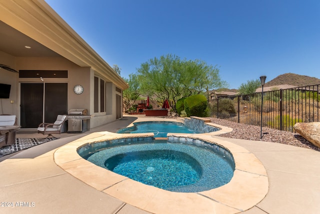 view of pool featuring a deck, an in ground hot tub, and a patio