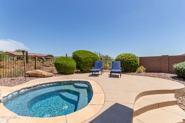 view of swimming pool with an in ground hot tub and a patio area