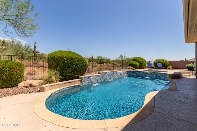 view of pool featuring pool water feature and a patio