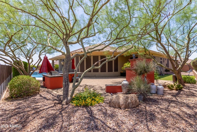 view of front of house with an outdoor kitchen and a patio area