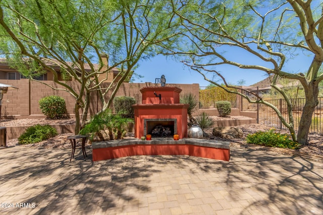 view of patio featuring an outdoor fireplace