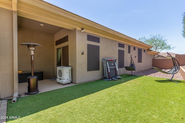 rear view of property with a yard and a patio area