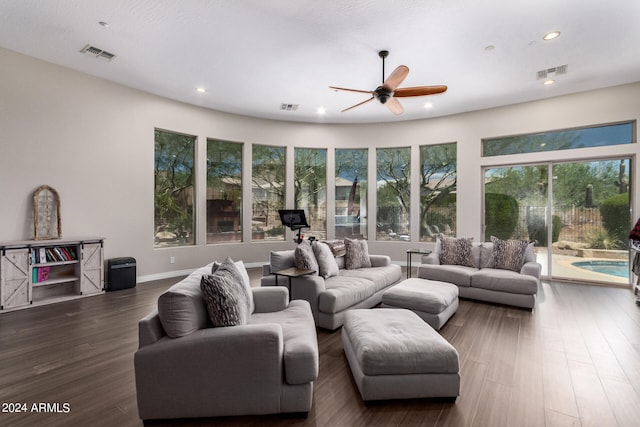 living room with ceiling fan and dark wood-type flooring