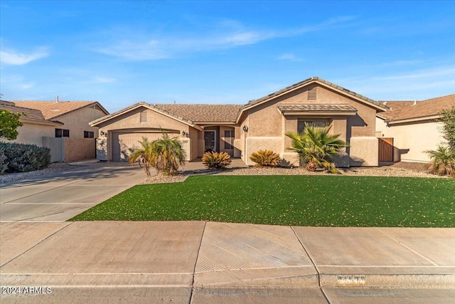 view of front of property with a front lawn and a garage