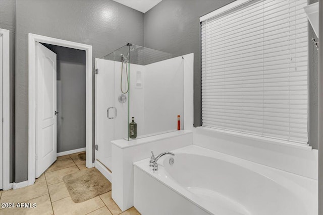 bathroom featuring plus walk in shower and tile patterned flooring