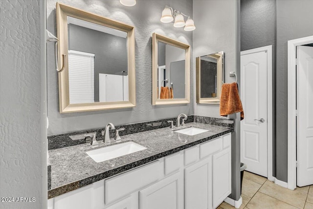 bathroom featuring tile patterned flooring and vanity