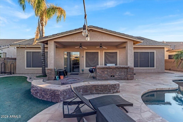 back of house featuring ceiling fan and a patio area