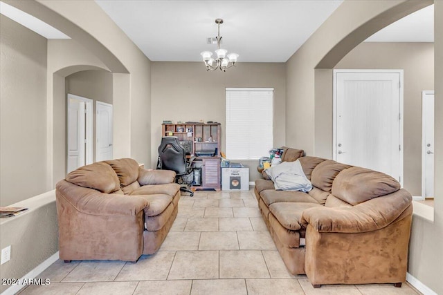 living room featuring a notable chandelier and light tile patterned floors