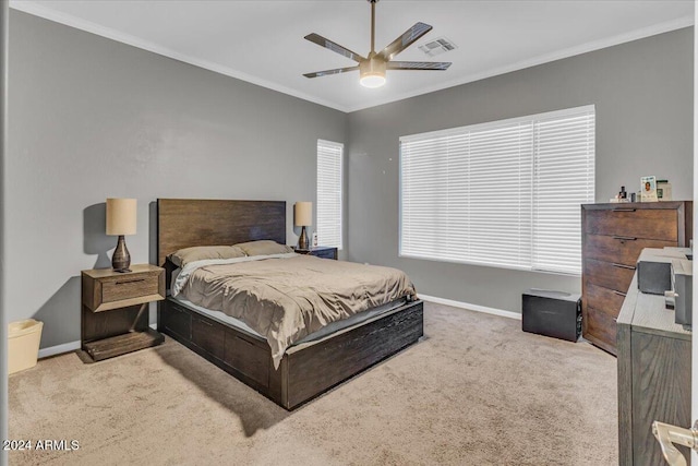 carpeted bedroom with ceiling fan and crown molding