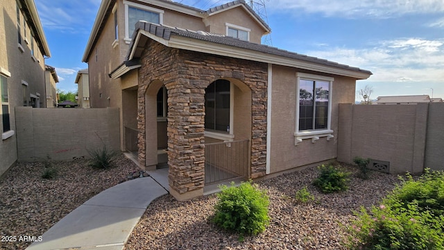 17802 N 114th Ln, Surprise, AZ 85378 - view of side of property with stone siding, stucco siding, and fence