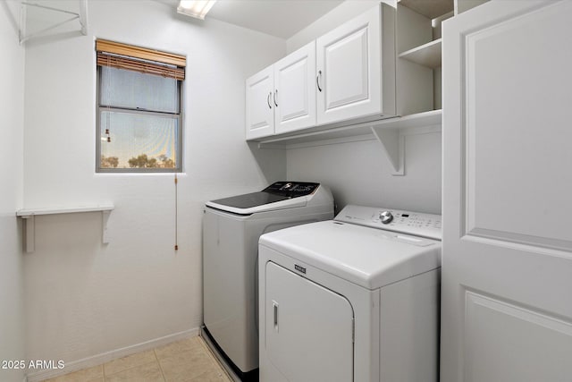 17802 N 114th Ln, Surprise, AZ 85378 - clothes washing area with washing machine and clothes dryer, cabinet space, baseboards, and light tile patterned floors