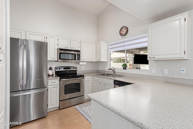 kitchen with light hardwood / wood-style flooring, stainless steel appliances, white cabinetry, and sink