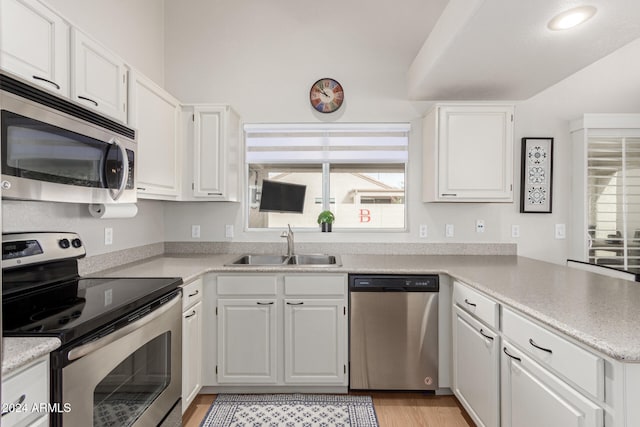 kitchen featuring white cabinetry, sink, and appliances with stainless steel finishes