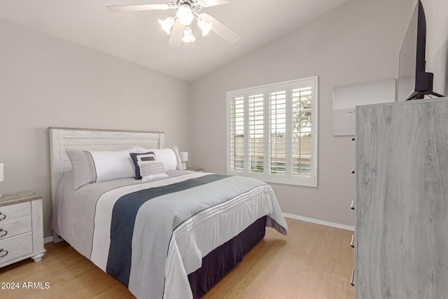 bedroom featuring wood-type flooring, vaulted ceiling, and ceiling fan