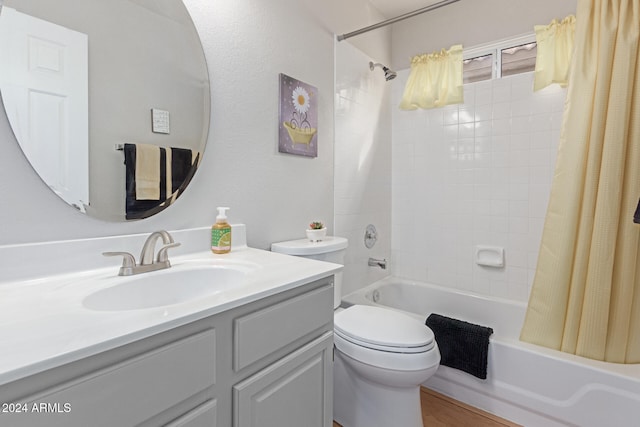 full bathroom featuring shower / bath combo with shower curtain, vanity, and toilet