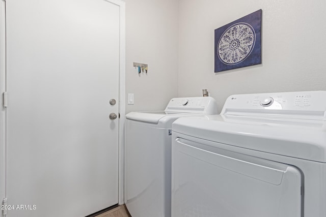 washroom featuring washer and dryer and light hardwood / wood-style flooring