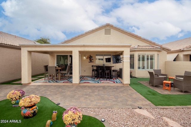 back of house with a patio