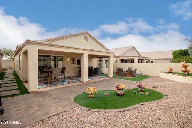 rear view of property with a patio area and central air condition unit