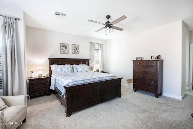 bedroom with a ceiling fan, baseboards, visible vents, and light carpet