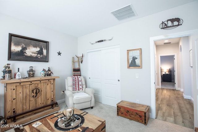 sitting room with visible vents and baseboards