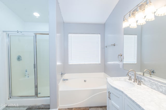 bathroom featuring plus walk in shower and vanity