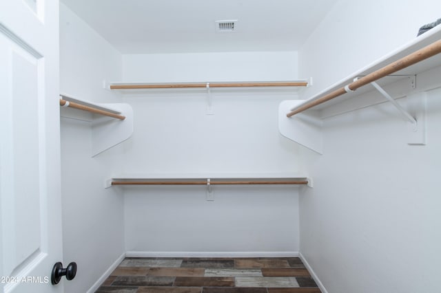 spacious closet featuring dark hardwood / wood-style floors